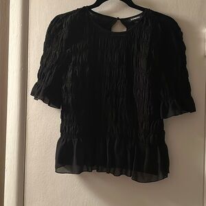 Black size medium Express top. Polyester with ruffle detail. New without tags